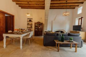 a living room with a table and a couch at The Yard Traditional Residence in Vasa Kilaniou