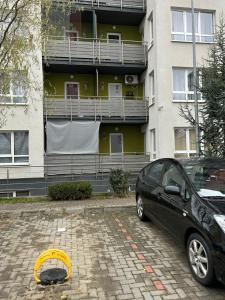 a car parked in front of a building with a yellow frisbee at One Rent in Braşov