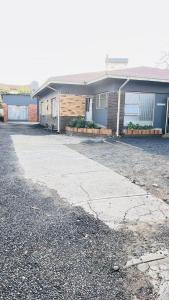 an empty driveway in front of a building at HostHub Guest House in Rustenburg