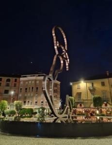 a large metal sculpture in front of a building at Fiore di langa in Alba