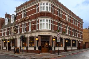 a large brick building on the corner of a street at The Brewers Inn in London