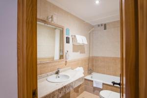 a bathroom with two sinks and a tub and a mirror at Alda Puerto Calderón in Oreña +76 photos