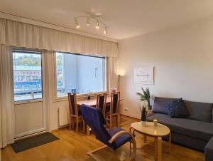 a living room with a couch and a table at Föri condo, sauna and parking in Turku
