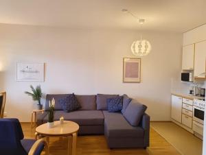 a living room with a couch and a table at Föri condo, sauna and parking in Turku +34 photos