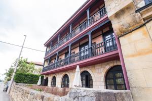 a building with an umbrella sitting outside of it at Alda Puerto Calderón in Oreña