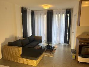 a living room with a couch and a glass table at Hotel Seeadler in Friedrichshafen