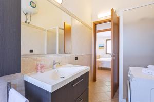 a bathroom with a sink and a mirror at Casa Luna in Tertenìa