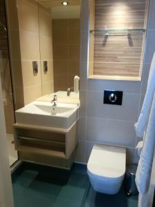 a bathroom with a sink and a toilet at The Queen's Head Wetherspoon in Tavistock