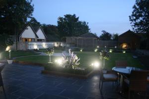 a garden at night with lights on the grass at Appletree Cottages in Mildenhall