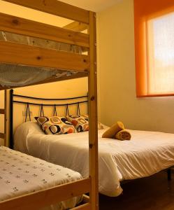 a bedroom with two bunk beds and a window at El Chalete in Otura +78 photos