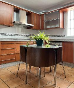 a kitchen with a table with plants on it at El Chalete in Otura