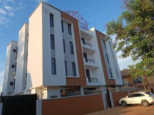 a white car parked in front of a building at Raya hotel juba in Juba