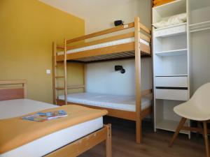 a bunk bed room with two bunk beds and a desk at Village de Gîtes Nature et Jardin in Bouère +9 photos