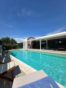 ein Schwimmbad vor einem Gebäude in der Unterkunft Villa Nika in Peroj