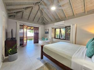 a bedroom with a large bed in a room at Villa Fantasy private beach and private pool in Rio Bueno +65 photos