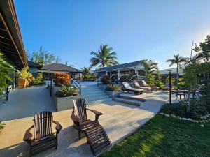 a group of benches sitting on a patio at Villa Fantasy private beach and private pool in Rio Bueno