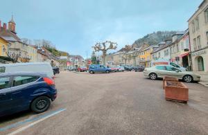 a city street with cars parked on the street at Le Petit Polinois in Poligny