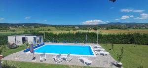 an overhead view of a swimming pool with chairs around it at City villa Bihac in Bihać