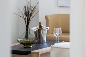 a table with a bottle of wine and a glass at Monaco Border - Bel appartement rénové - CM in Beausoleil