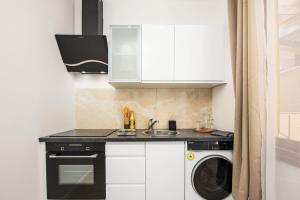a kitchen with a sink and a washing machine at Monaco Border - Bel appartement rénové - CM in Beausoleil +19 photos