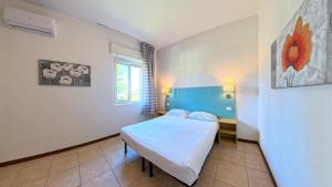 a small room with a bed and a window at Villenpark Sanghen in Manerba del Garda +41 photos