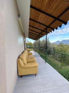 a row of couches sitting on a porch at doa house 2 in Tirana