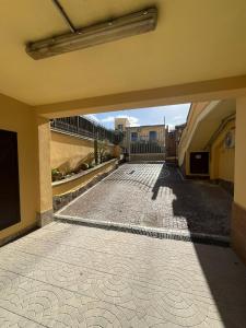 an empty courtyard of a building with a tile floor at Aurora Rooms in Pomigliano dʼArco +47 photos