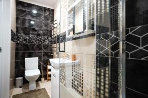 a bathroom with a toilet and a shower at Garden Cottage in Šiauliai +10 photos