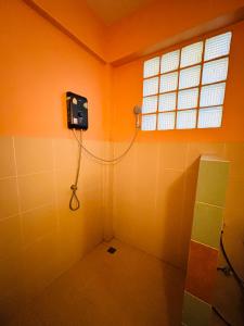 a bathroom with a shower in the corner with a window at Moondance Cottage Inn in Ko Chang +31 photos