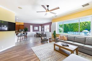a living room with a couch and a table at Mini Golf, Saltwater Pool & Spa by MariamsBnb in Desert Hot Springs