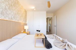 a bedroom with a bed and a table with a glass of wine at Gorgeous Paraiso FREE WIFI in Playa Paraiso +30 photos