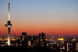 a city skyline with a radio tower at sunset at Euromast in Rotterdam