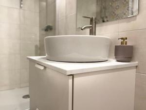 Un baño blanco con lavabo y ducha. en Apartment Zare, en Banjol