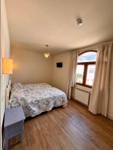 a bedroom with a bed and a large window at Hotel Restaurante Paneque in Villanueva del Trabuco +15 photos