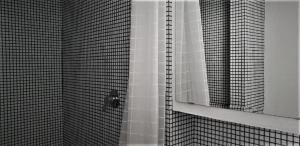 uma casa de banho com um chuveiro e um espelho. em Casa Milano - Apartments and Rooms - Duomo's Whisper, balcony em Milão