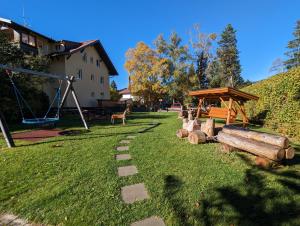 a park with a playground with logs and a swing at Alpgold C1 oder Alpherz A8 Montana Haus in Oberstdorf