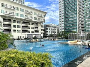 a large swimming pool in a city with buildings at Solinea T3 805-A Elegant studio in Cebu City