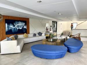 a living room with a couch and blue chairs at Solinea T3 805-A Elegant studio in Cebu City