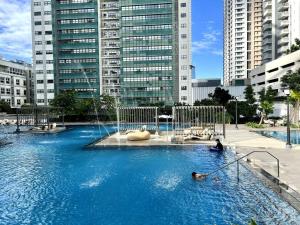 a pool of blue water in a city with buildings at Solinea T3 805-A Elegant studio in Cebu City