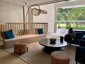 a person sitting on a couch in a living room at Solinea T3 805-A Elegant studio in Cebu City