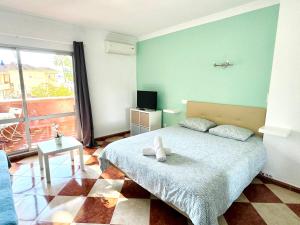 a bedroom with a bed with a teddy bear on it at G&G Benalbeach Sea Views in Benalmádena
