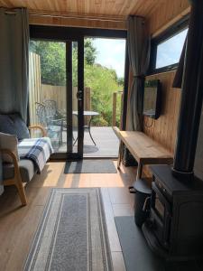 a room with a porch with a stove and a table at The Lookout in Padstow