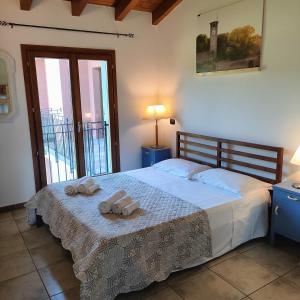 Postel nebo postele na pokoji v ubytování Agriturismo borgo del mincio