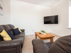 a living room with a couch and a coffee table at 4 Lower Kessock Street in Inverness