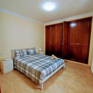 a bedroom with a bed and wooden cabinets at Duplex Elegant in Genovés