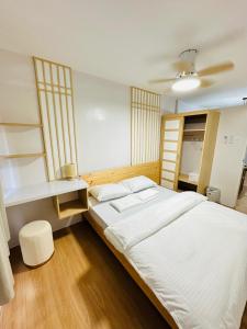 a bedroom with a large white bed and shelves at Tiffany's Place in Imus