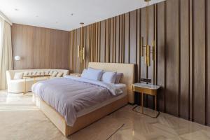 a bedroom with a king sized bed and a couch at Luxury 3BDR Apartment, Pool & Beach Access in Dubai +56 photos