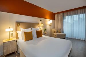Postel nebo postele na pokoji v ubytování Hôtel Arcanse by Inwood Hotels