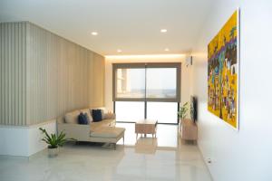 a living room with a couch and a chair at Apart JC Edificio Victor in Praia