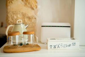 a kitchen counter with a blender and a box at Il Fico Luxury Suite & SPA in Polignano a Mare